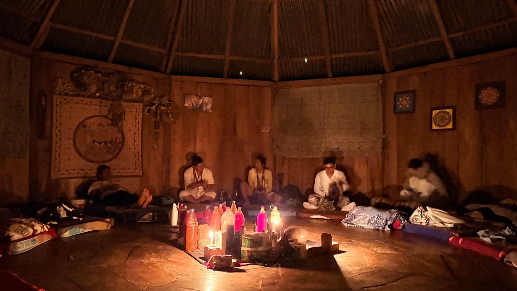 Participants gathered for an evening plant-medicine ceremony inside a traditional maloca